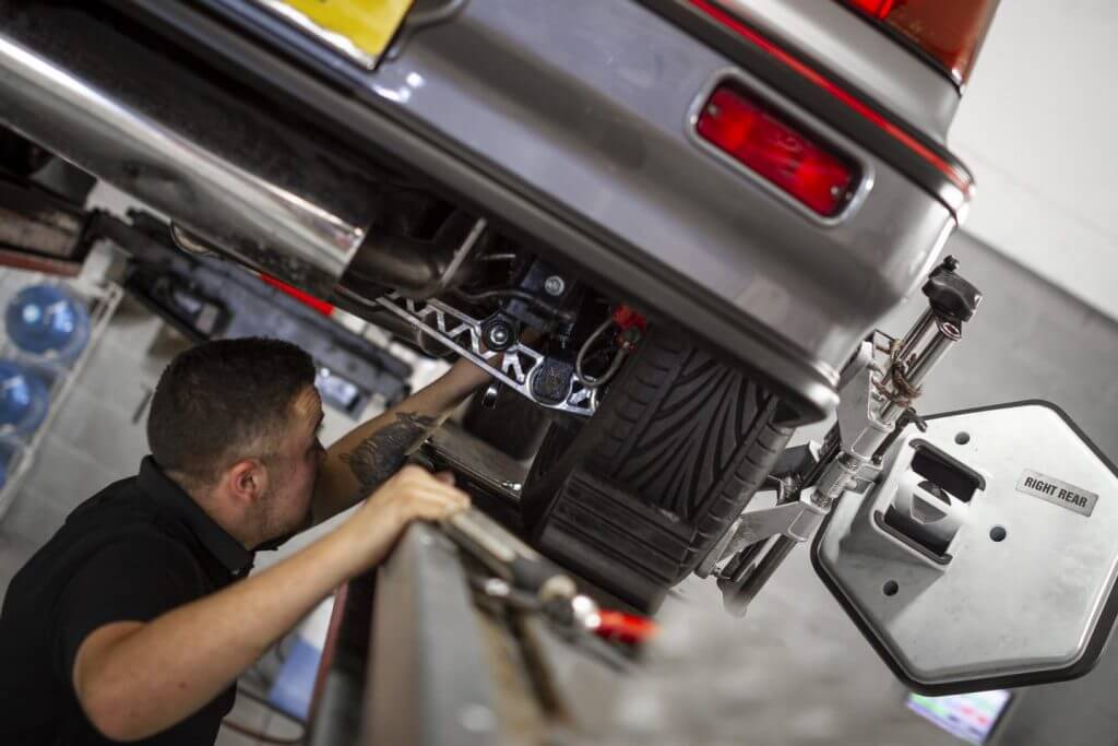 mechanic underneath a third generation honda civic