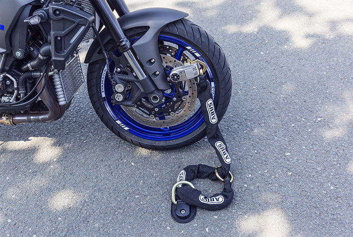 Ground anchor motorcycle lock