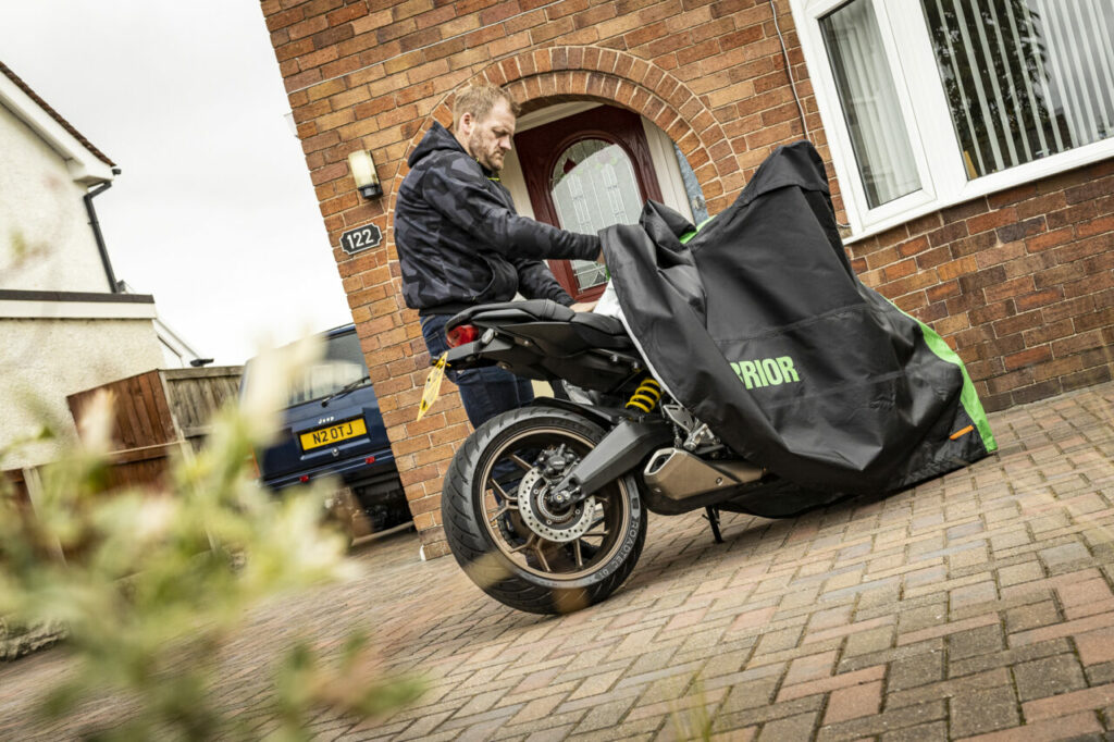 Putting the cover over the motorbike