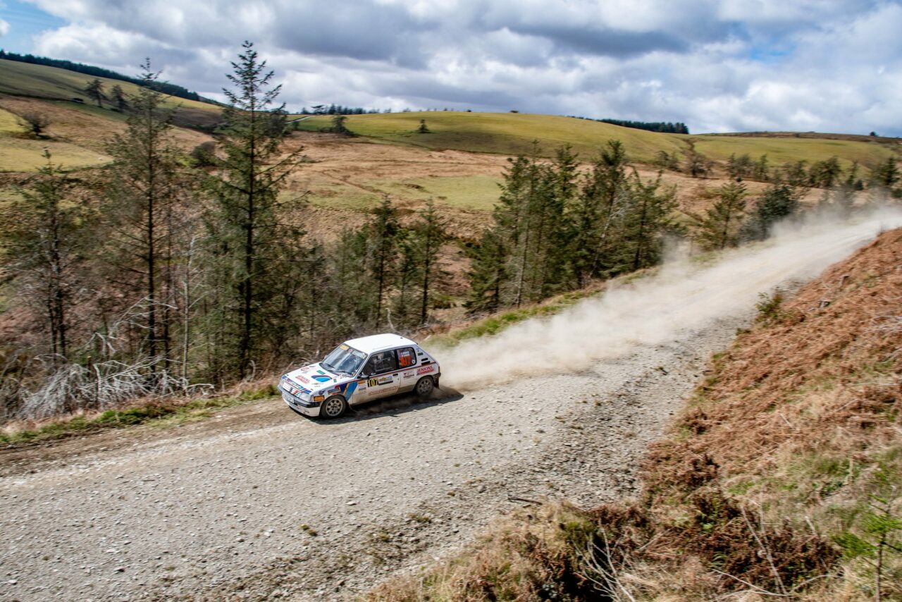 Peugeot 205 speeding through a rally stage