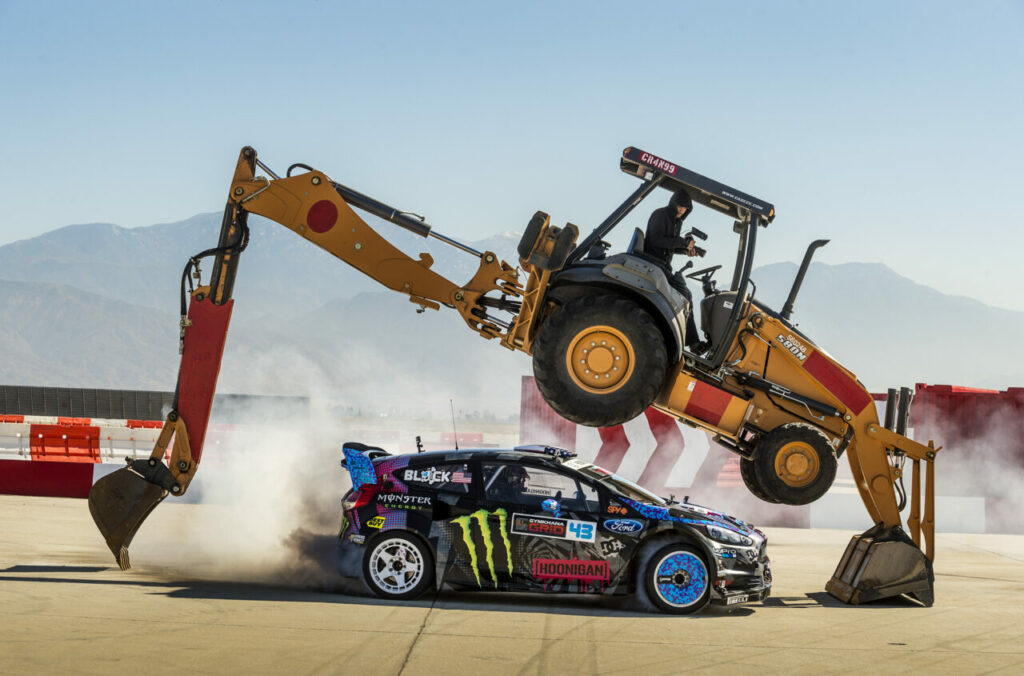 Ken Block sliding under a back hoe filming for Gymkhana 6.